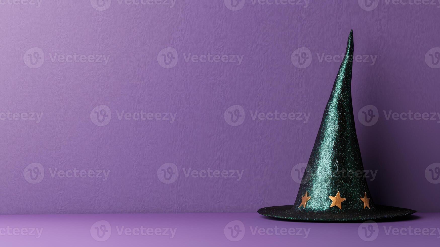 Sparkly green witch hat with gold stars on a purple background photo