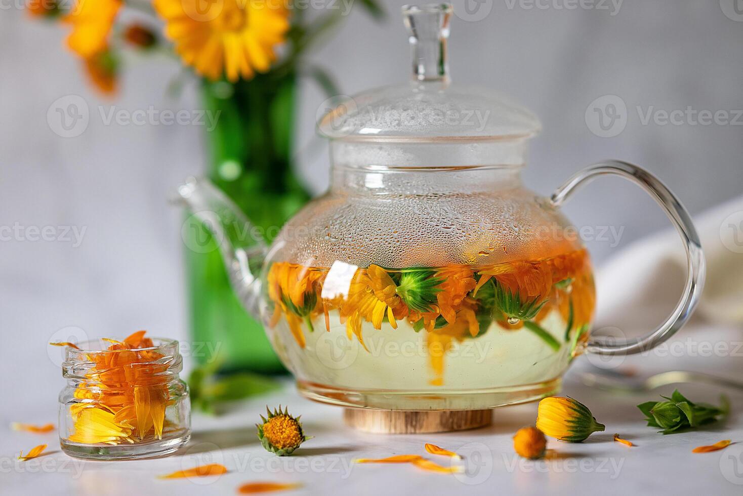 The elements in the image, including the thermometer and flower-infused tea, hint at a soothing and healing process photo