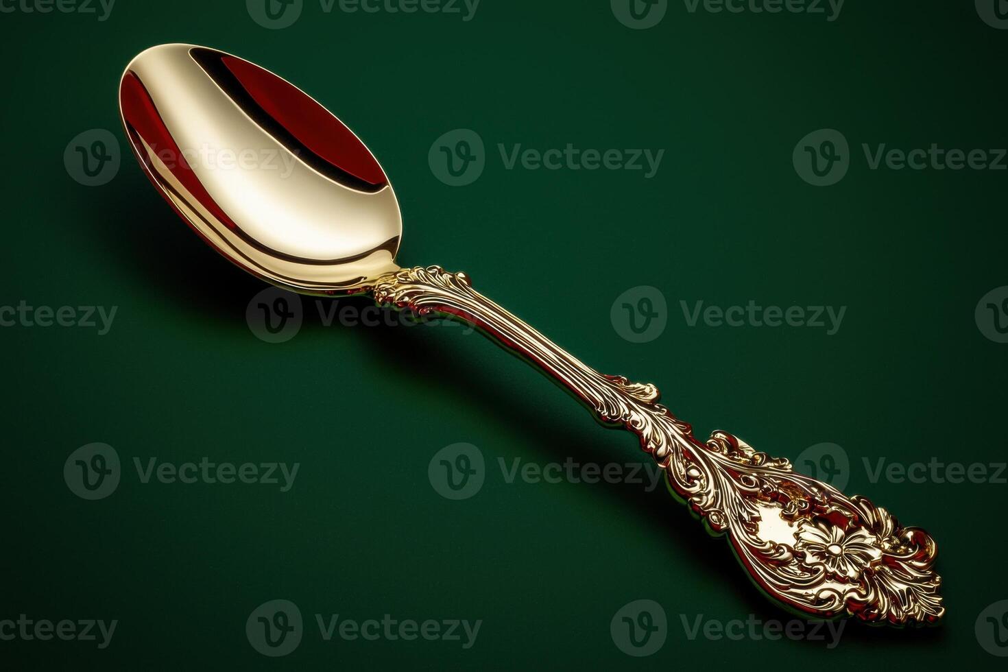 Elegant golden spoon on a green background photo