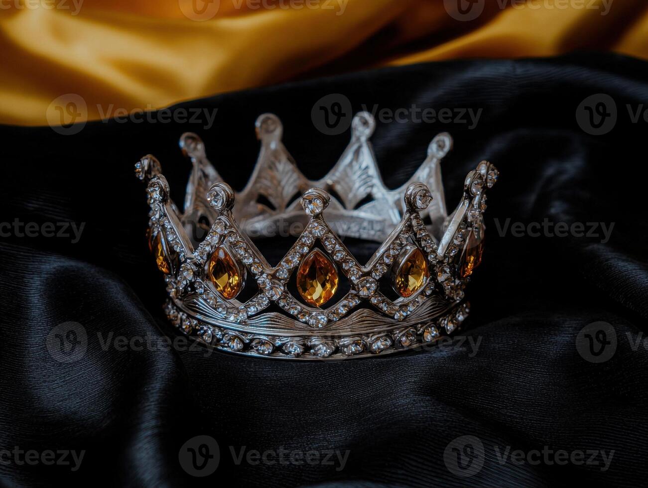 Elegant crown with gemstones on draped fabric photo