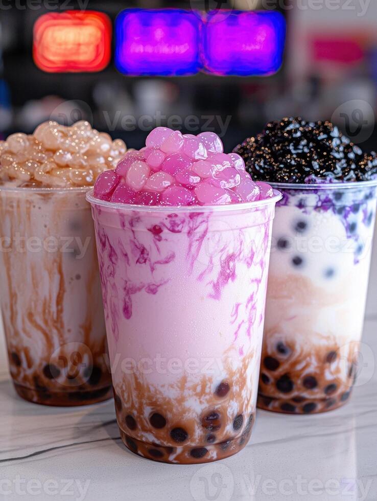 Three bubble tea drinks with different flavored toppings photo