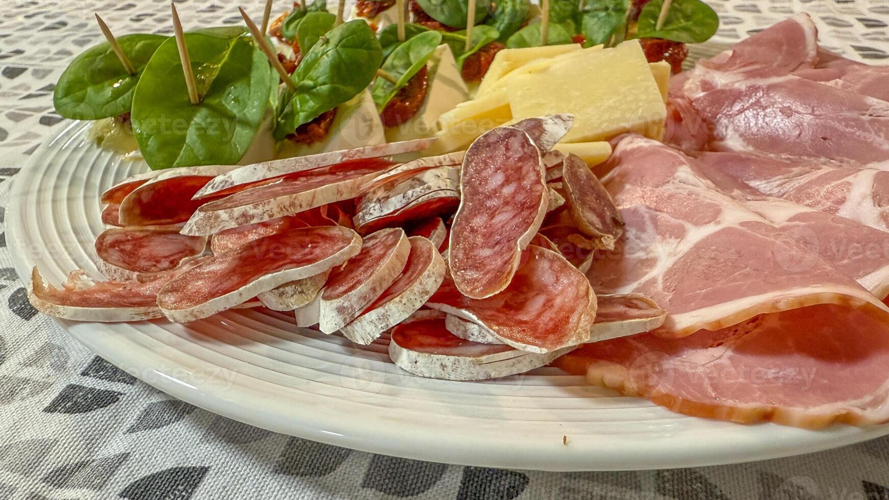 A festive Italian antipasto platter featuring cured meats, cheese, and spinach skewers, perfect for celebrating Christmas or family gatherings photo