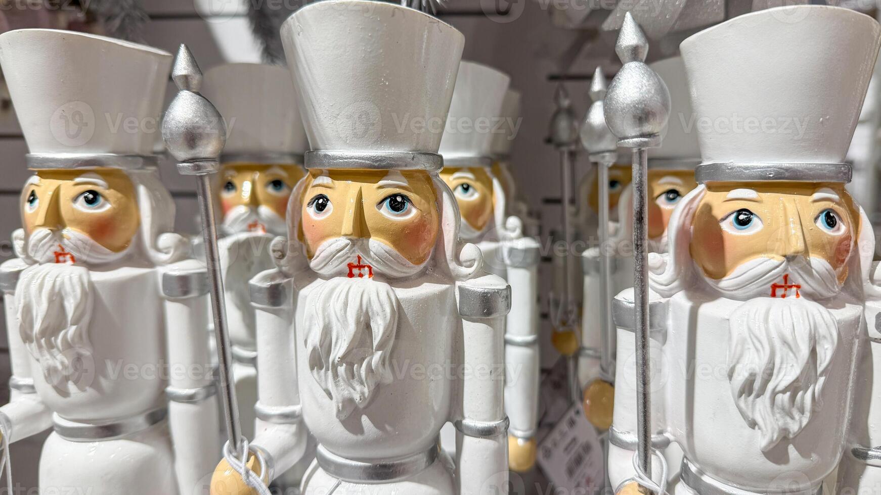 Close up of traditional wooden nutcracker soldiers in white, symbolizing festive Christmas decor and holiday traditions photo