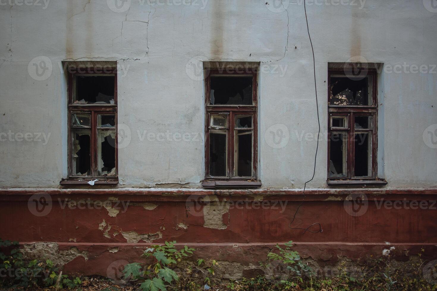 Broken windows of abandoned building photo