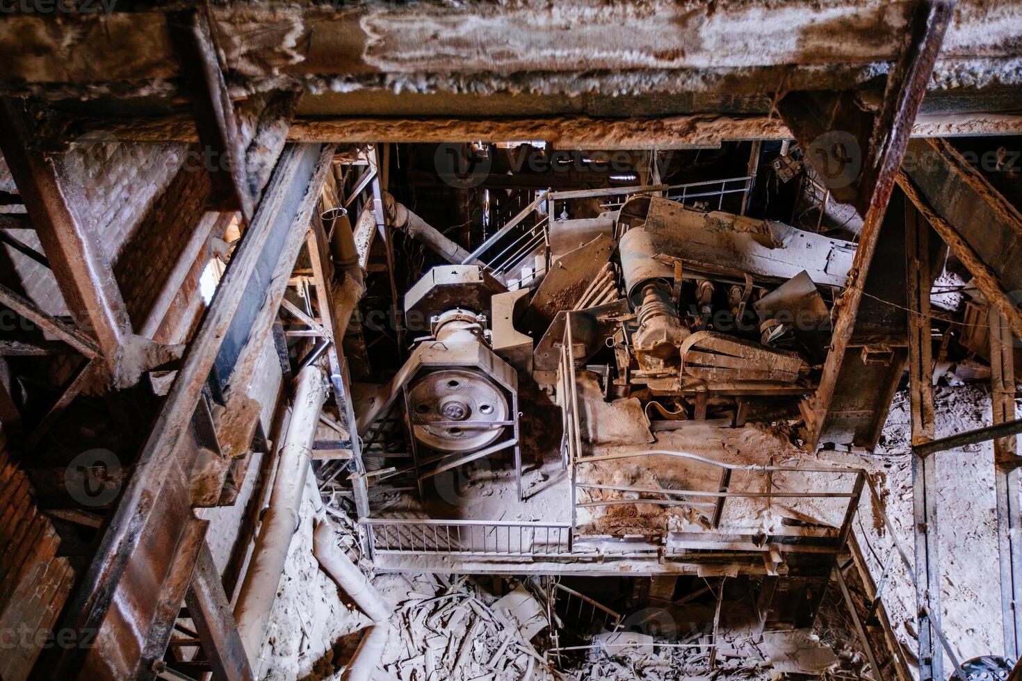 Old broken empty abandoned factory with rusty machines photo