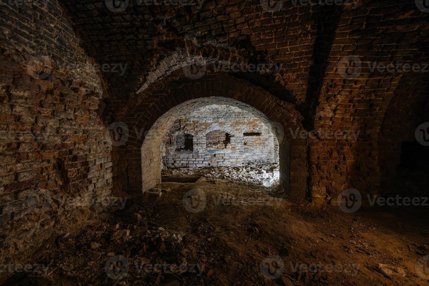 Dark and creepy vaulted red brick dungeon photo