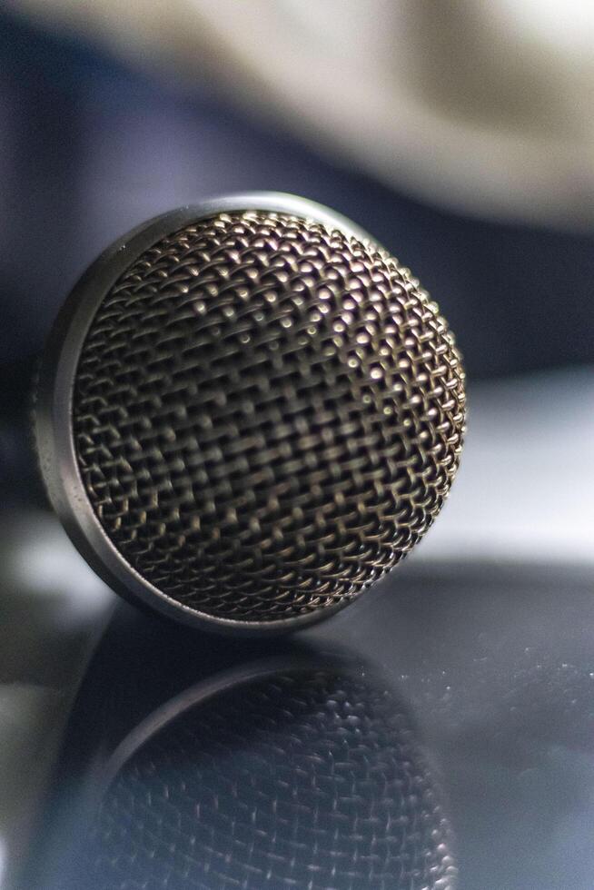 A microphone on a table with a reflection photo