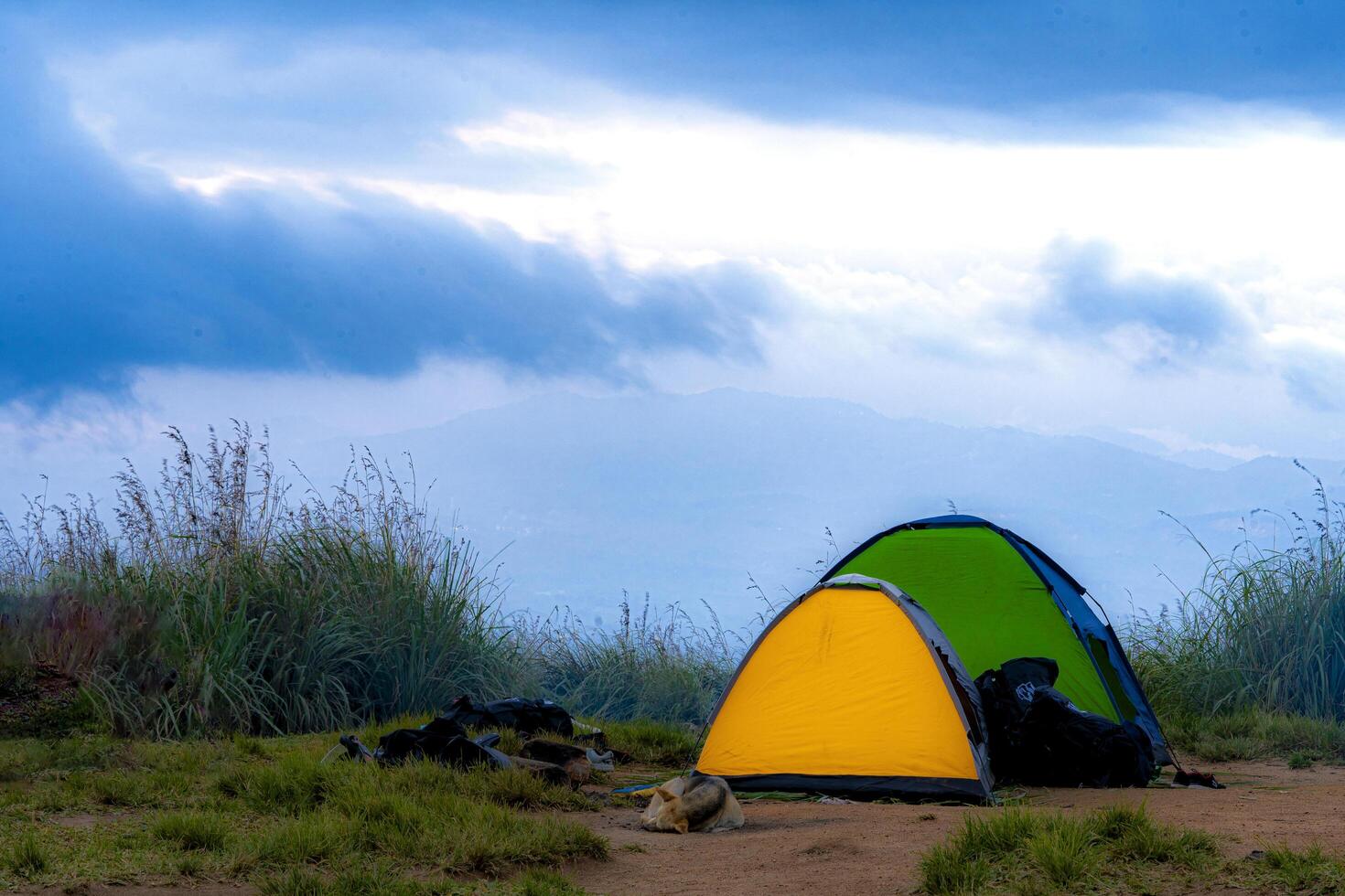 A tent is set up on a dirt field photo