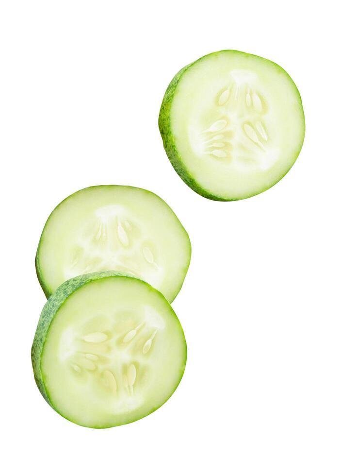 A set of fresh green cucumber slices in circle shape in stack isolated on white background with clipping path photo