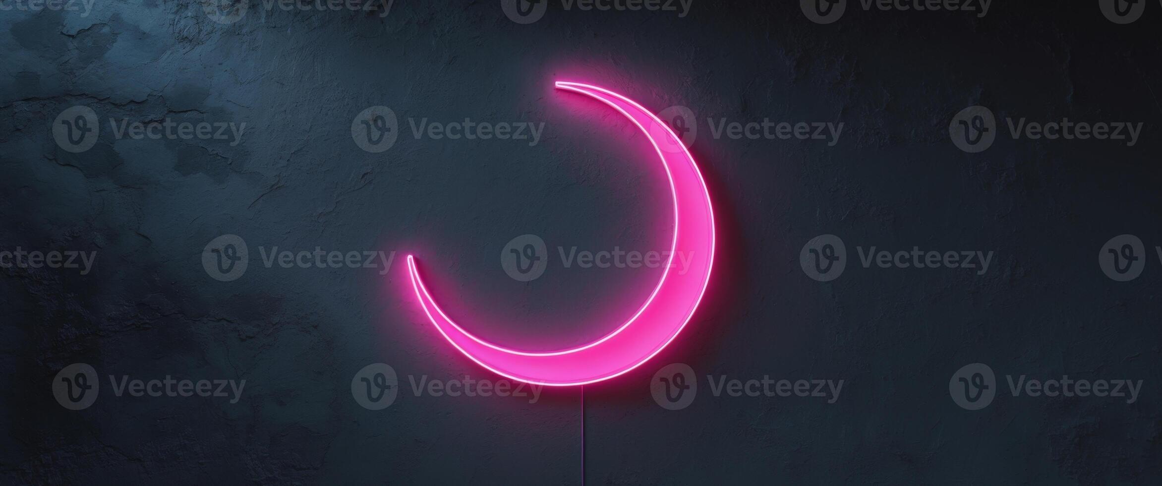 Neon Pink Crescent Moon Sign Illuminating Dark Wall Surface photo