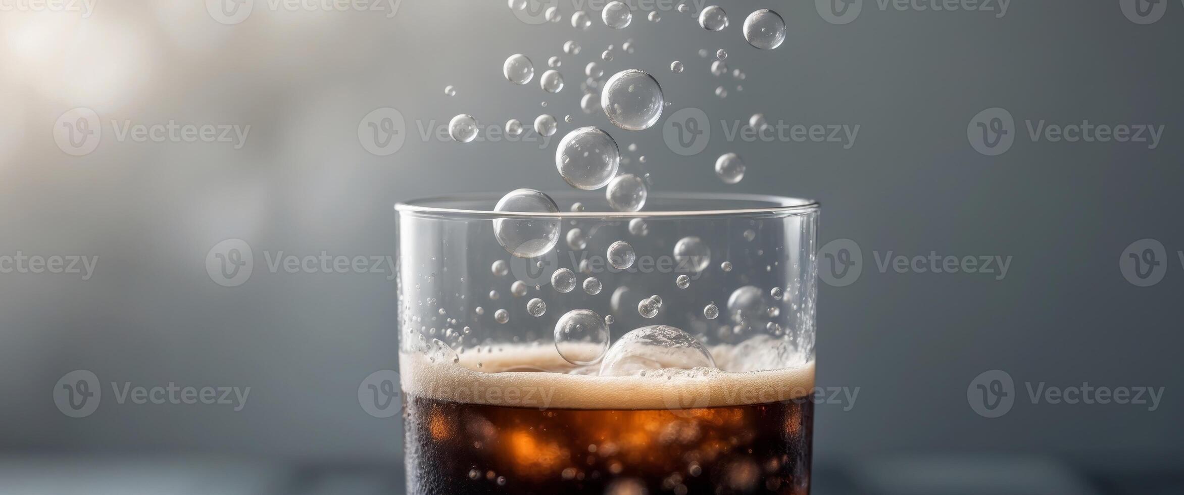Rising Bubbles in Dark Beverage with Soft Background photo