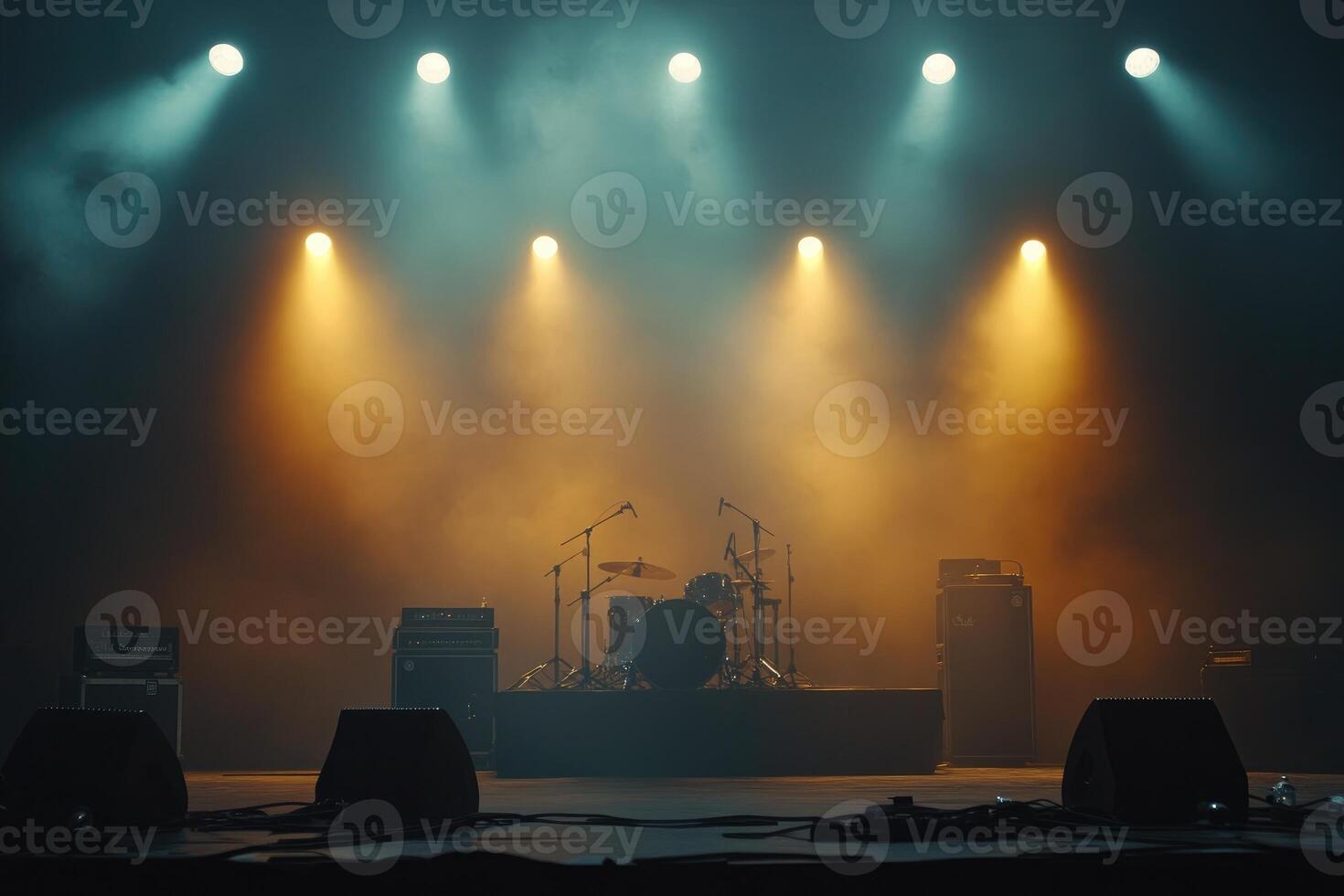 Drum set and amplifiers waiting for the band on a foggy stage illuminated by spotlights photo