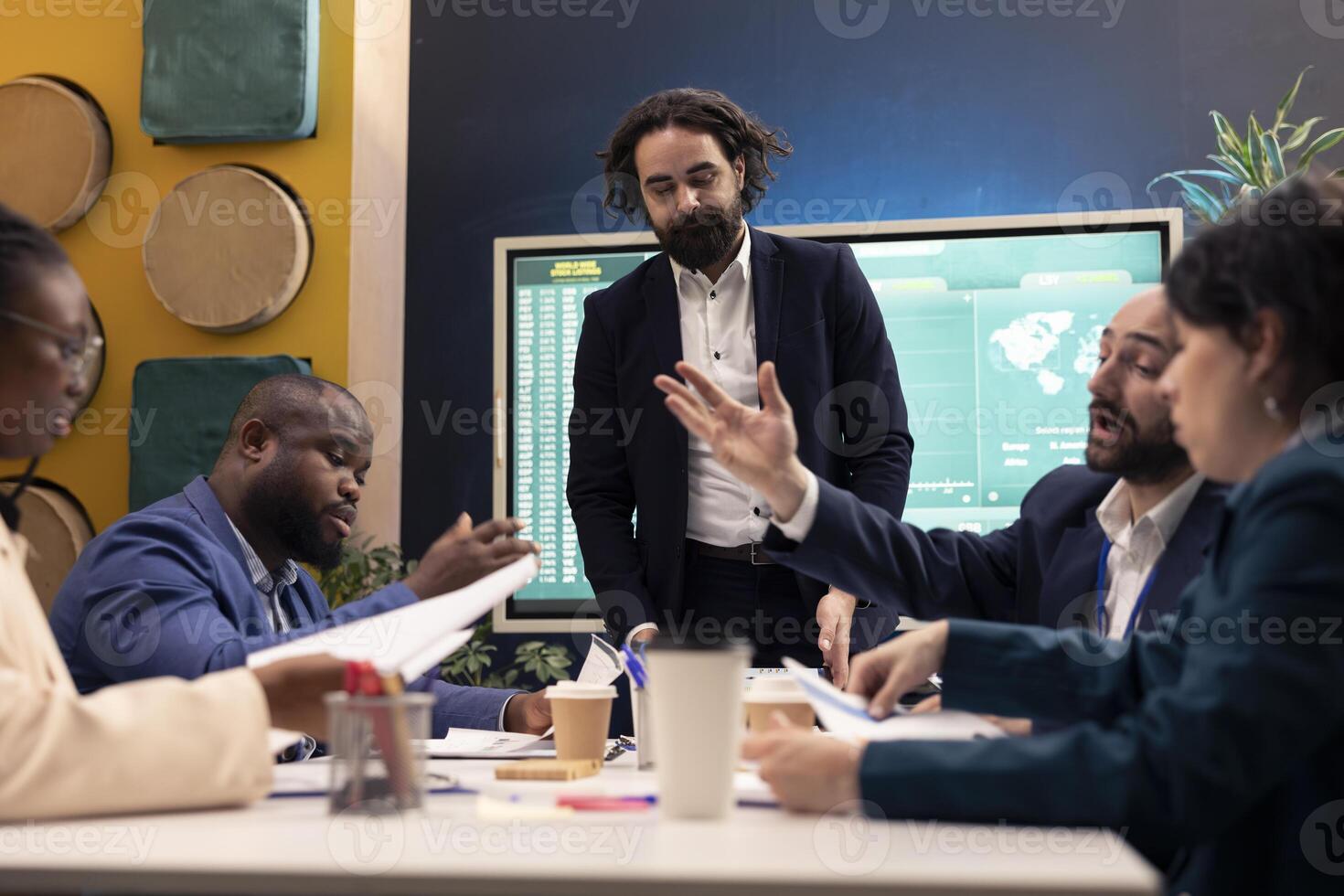 Management team evaluating success and performance metrics on interactive board, using infographics and data reports for annual plans. Manager and staff identify market demands. photo