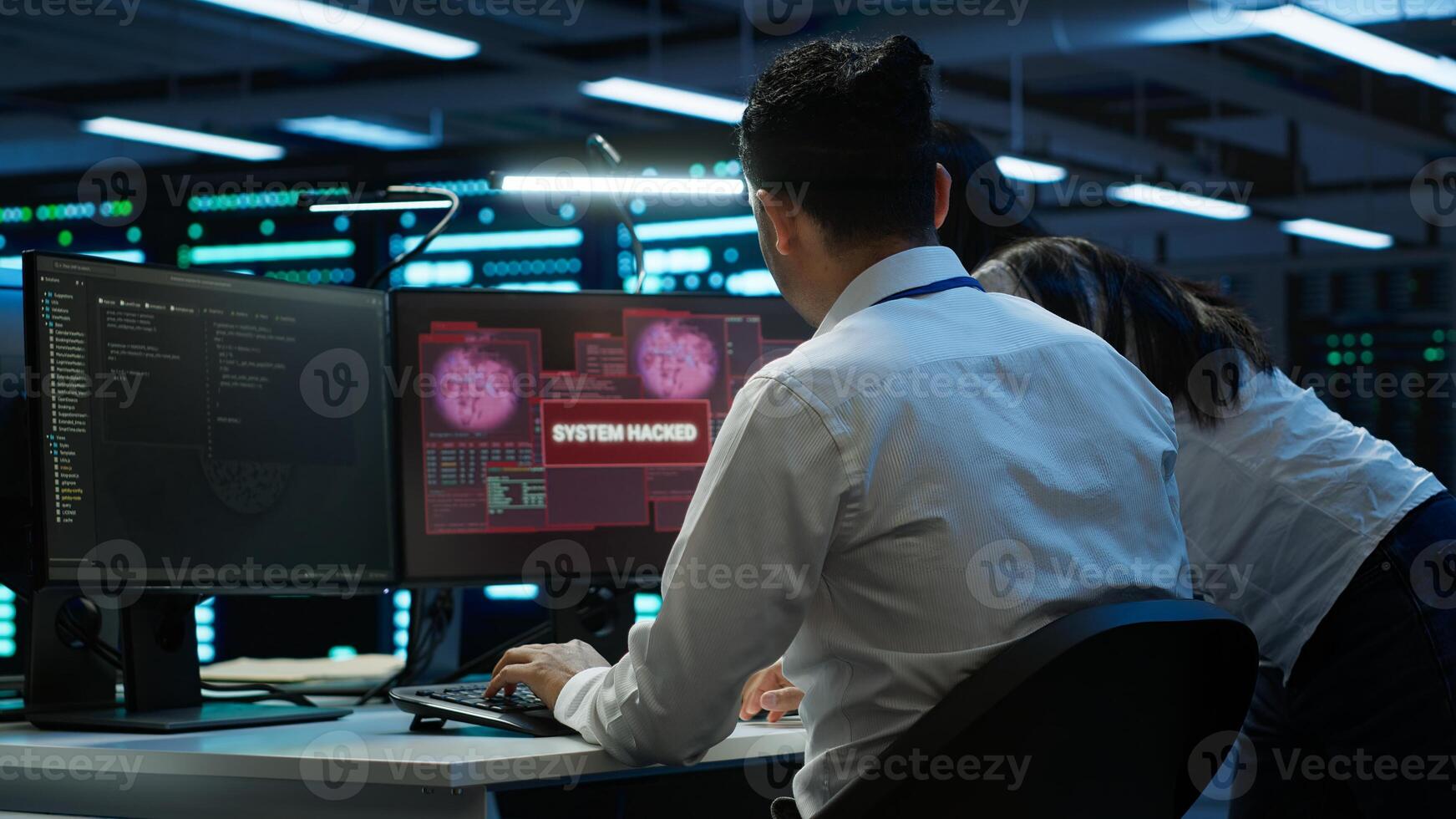 Computer scientists in server room protect hardware from hacker attack stealing sensitive information. Data center cybersecurity division teamworking colleagues fighting security breach, camera A photo