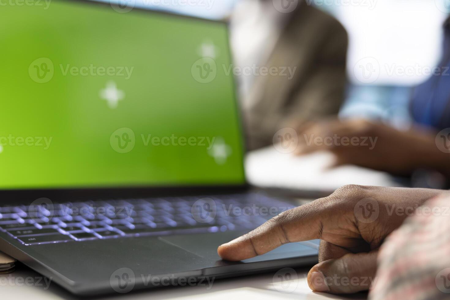 Organizational staff looking at device with green screen during a meeting, ensuring progress for an expansion project. Professional forecast affiliates sharing ideas for data management. Close up. photo