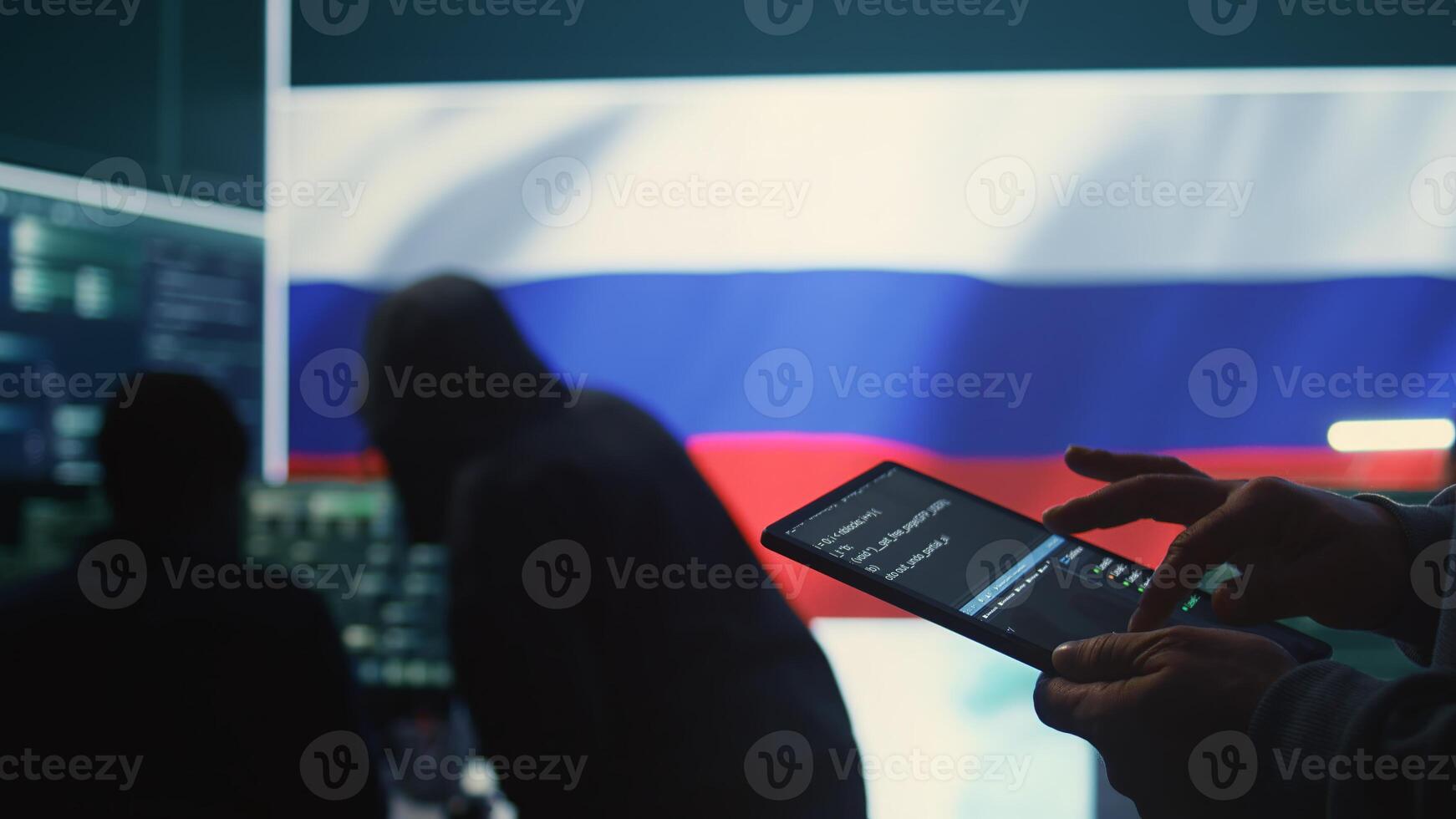 Person uses tablet in governmental cyber security room working under the Russian flag. Making cyber threats, hacking systems to gain unauthorized access, and spreading fake news. Close up. Camera B. photo
