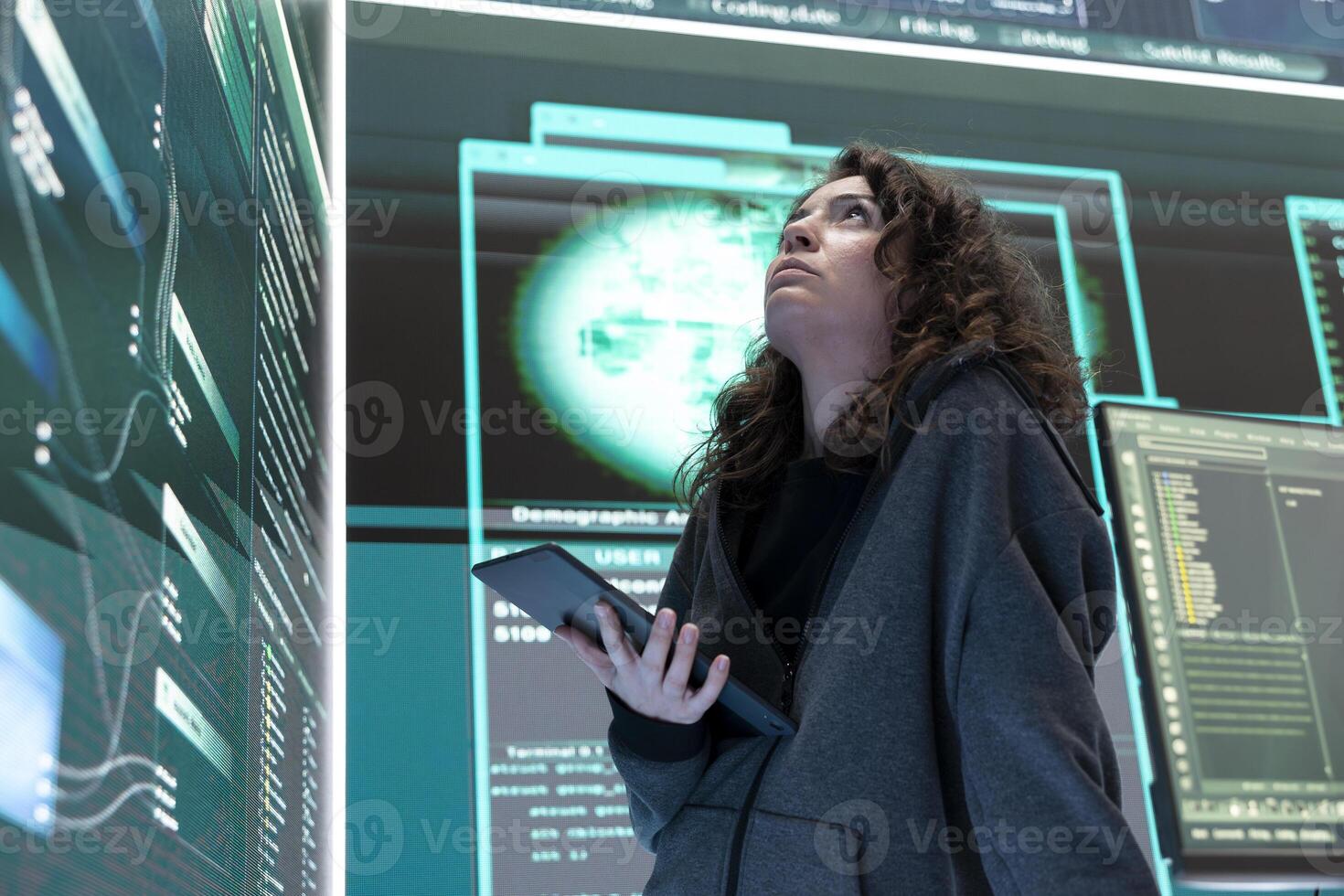 Female hacker breaching network security with advanced techniques, cyber defense in action. IT expert examines important hybrid war intelligence on a big screen, gaining access. photo
