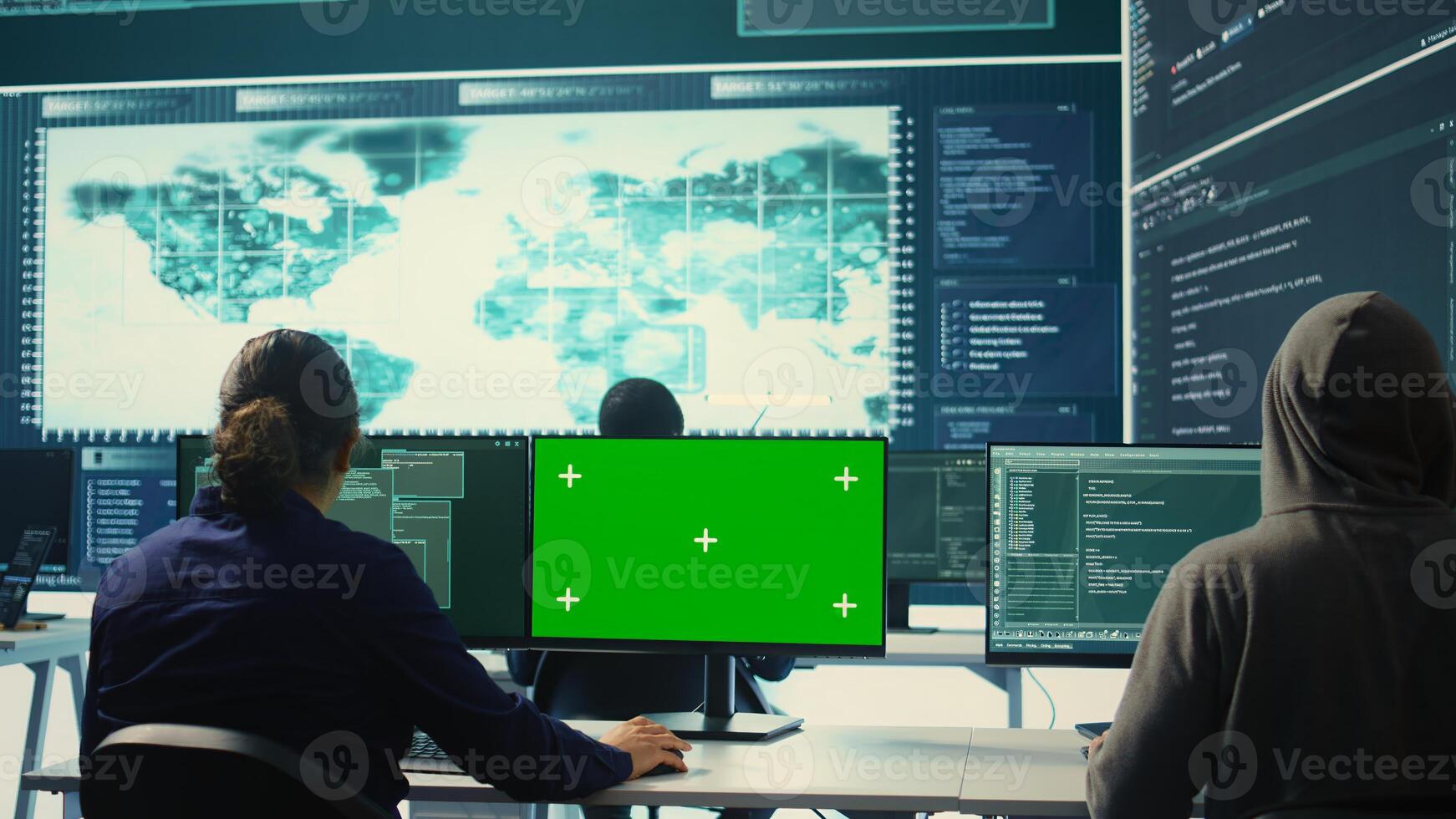 Governmental hackers using green screen in performing cyber security monitoring and threat detection. Examining network security and protection against cyber attacks, national intelligence. Camera B. photo