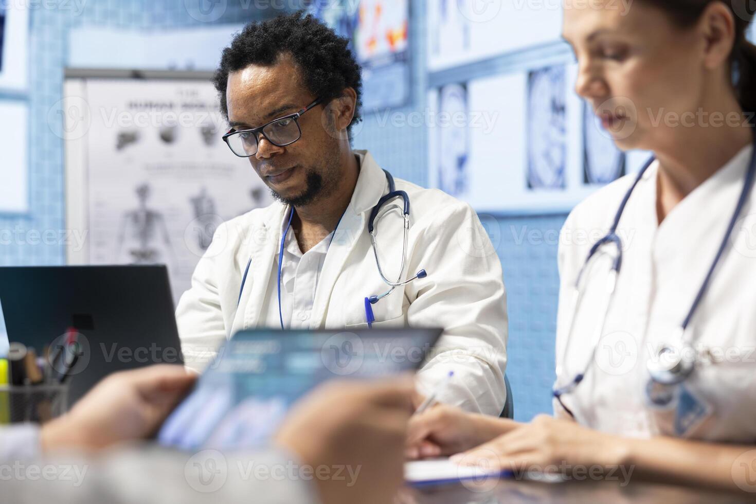 Medical experts collaborating on x ray analysis in a private clinic, collective work ensuring precise diagnostics and effective treatment plans. Highlighting professional healthcare teamwork. photo