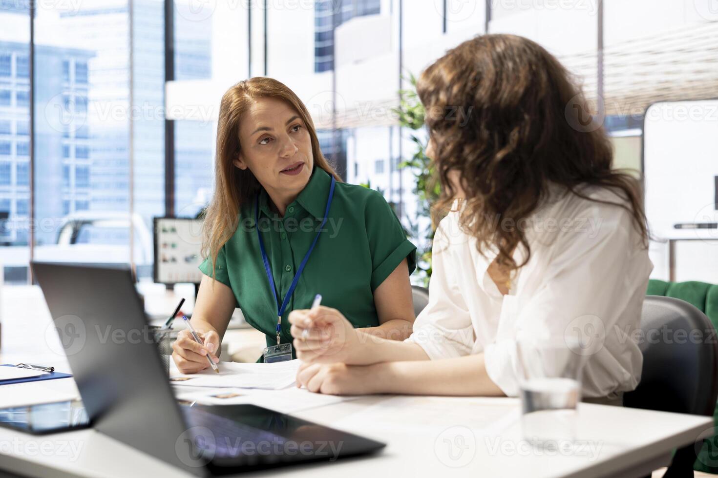 Teamworking recruiters doing brainstorming, hiring for newly opened company position, looking over CVs matching job description. HR expert and colleague analyzing candidates resumes photo
