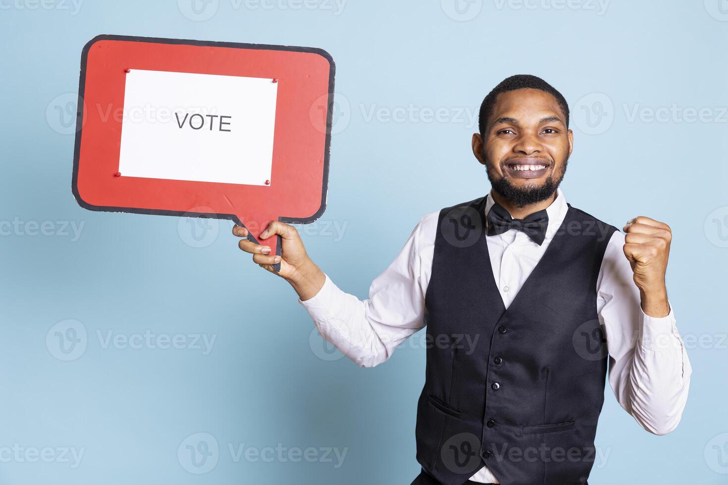 Professional front desk staff presenting a red speech bubble with a vote message, pushing guests into politics. Five star hotel personnel showing the billboard icon for an ad commercial. photo