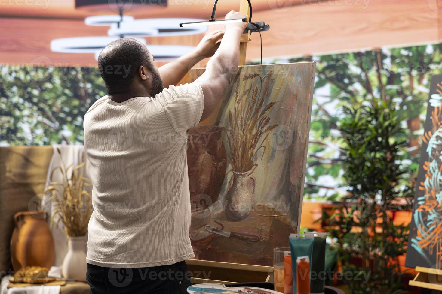 In a creative workshop, artist mixes pigments to achieve the perfect dye shade. Using professional art supplies to create a beautiful masterpiece on canvas, quality time in atelier. photo