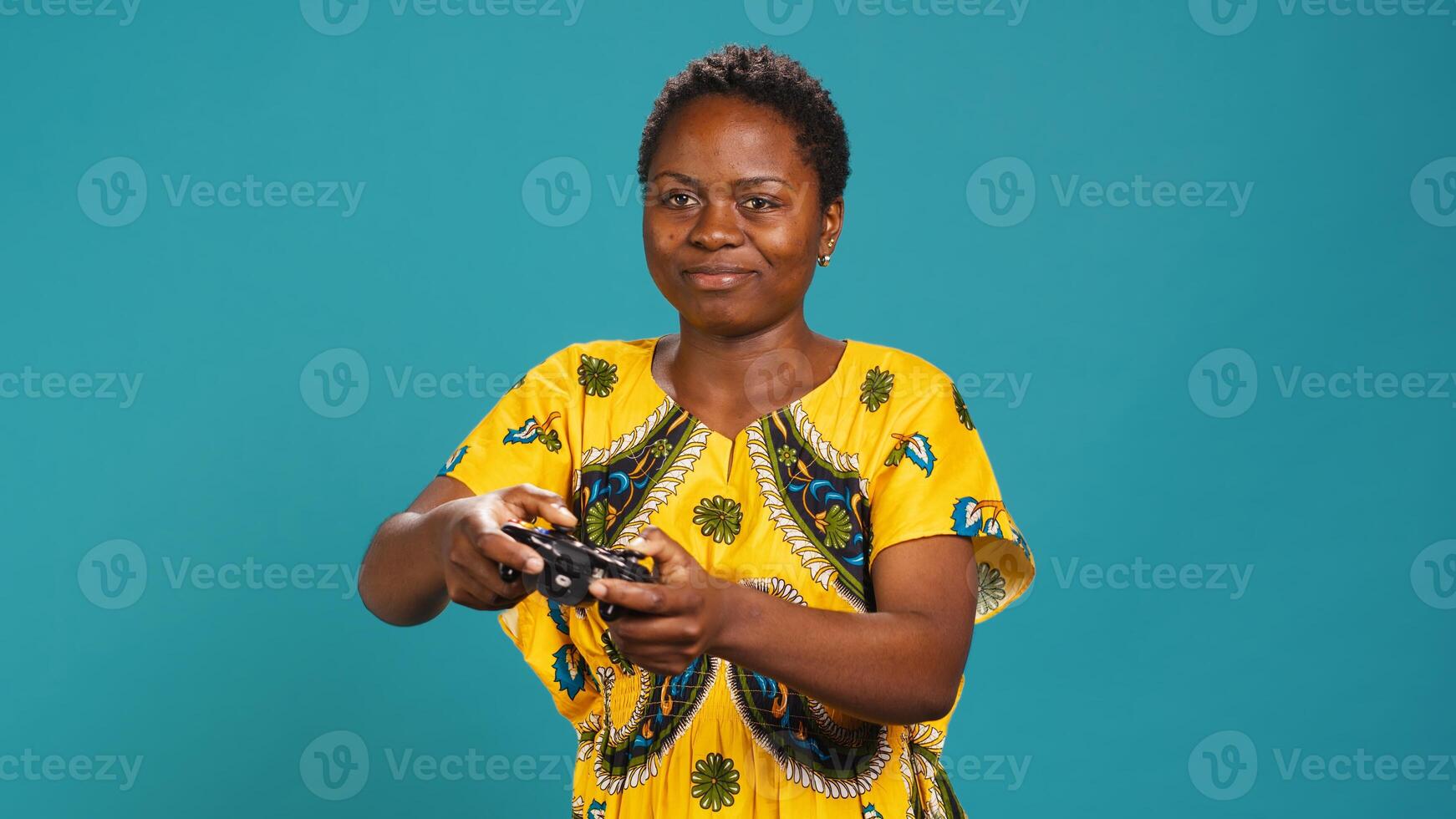 Optimistic confident woman playing videogames on console in studio, having fun with online e sport tournament with a controller. Young gamer enjoys gaming for leisure and relaxation. Camera A. photo