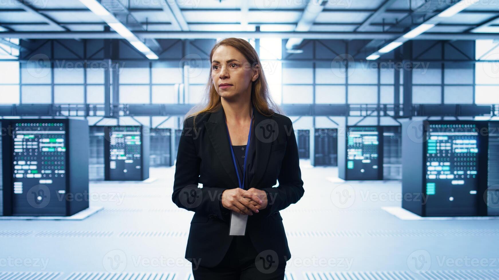 Admin walking in data center, monitoring systems to identify root cause of errors. IT specialist in server farm establishment doing diagnosis, looking for equipment bugs in need of repairing, camera B photo