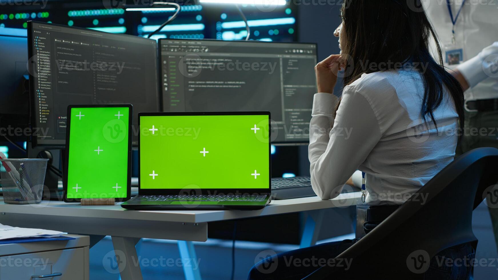 Engineers in data center monitoring security threats using chroma key devices. Experts using isolated screen tablet and laptop, ensuring compliance with regulations, camera A photo