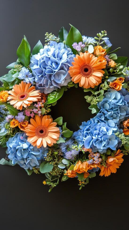 A wreath with blue and orange flowers on a black background photo