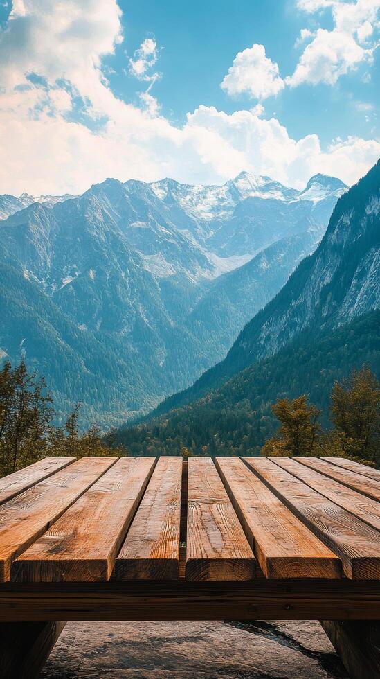 Wooden table on the mountain with mountains in the background photo