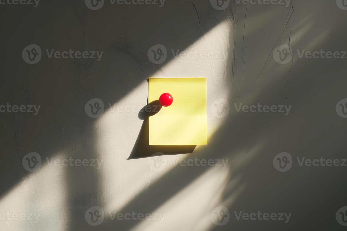 Yellow Sticky Note Red Pushpin on Gray Wall photo