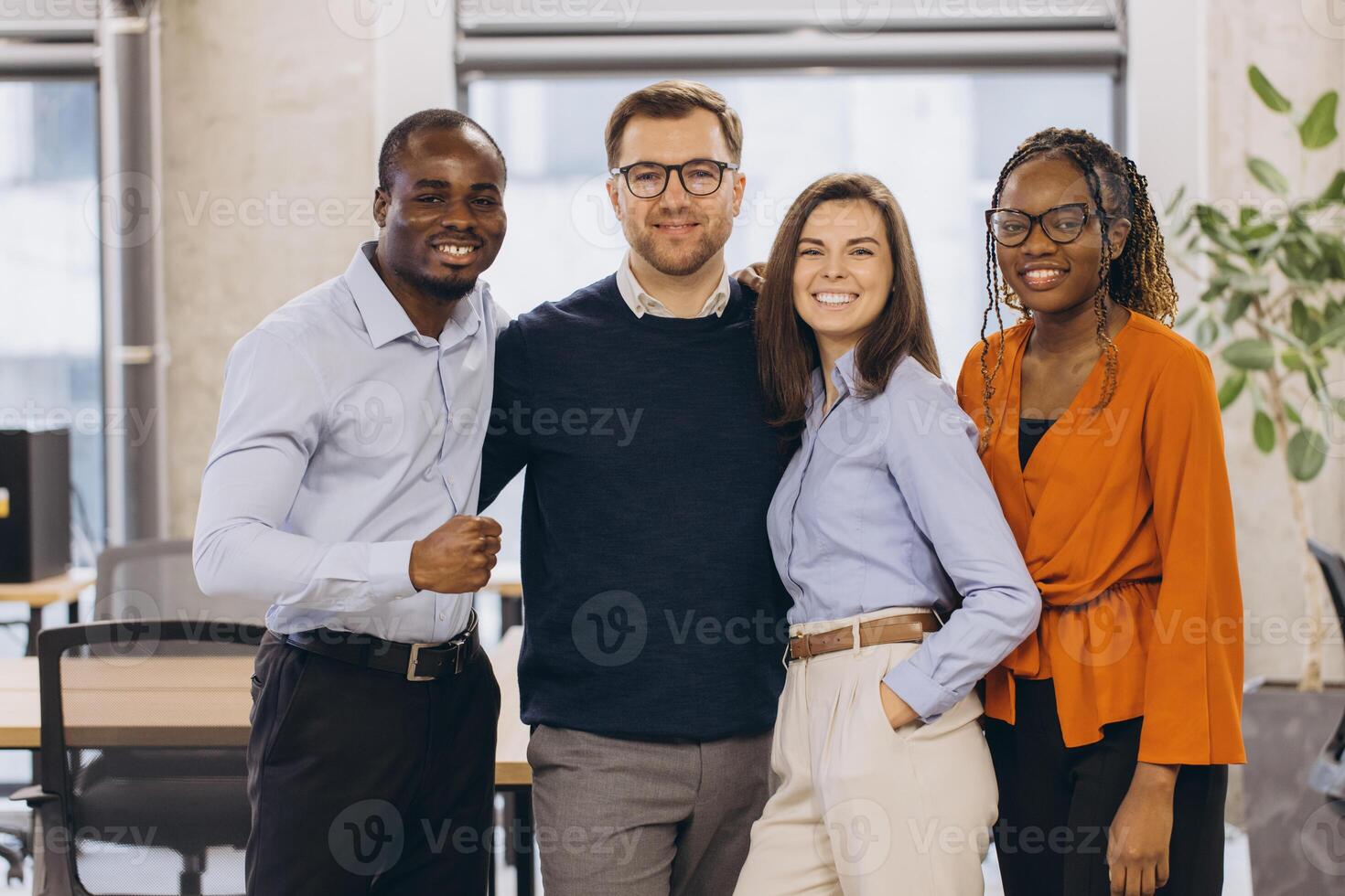 Group of multi ethnic business people standing together in the office, embracing teamwork and diversity photo