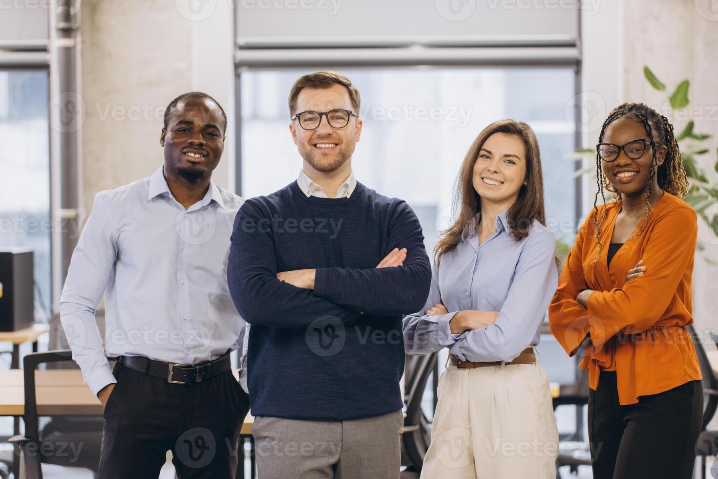 Confident businesspeople standing together in modern office, representing teamwork, diversity, and success in corporate environment photo