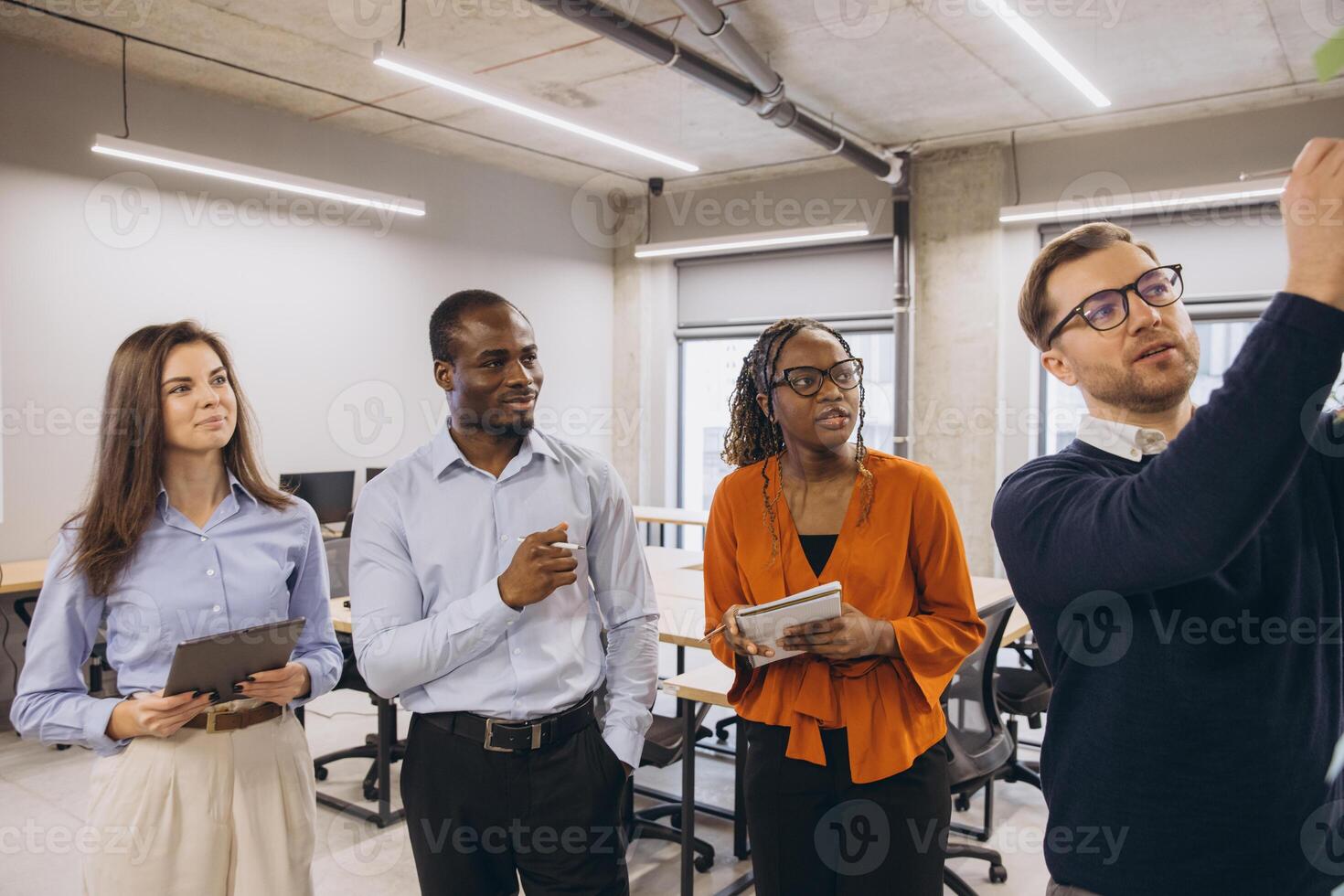 Business colleagues collaborating on a project, sharing ideas and strategies in a modern office environment photo