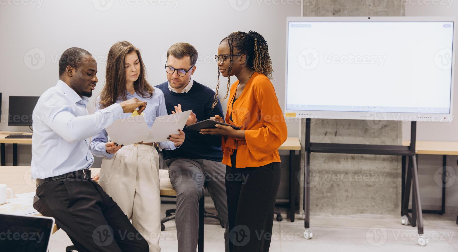 Group of professionals discussing ideas in a contemporary office environment, emphasizing teamwork and diversity in a business context photo