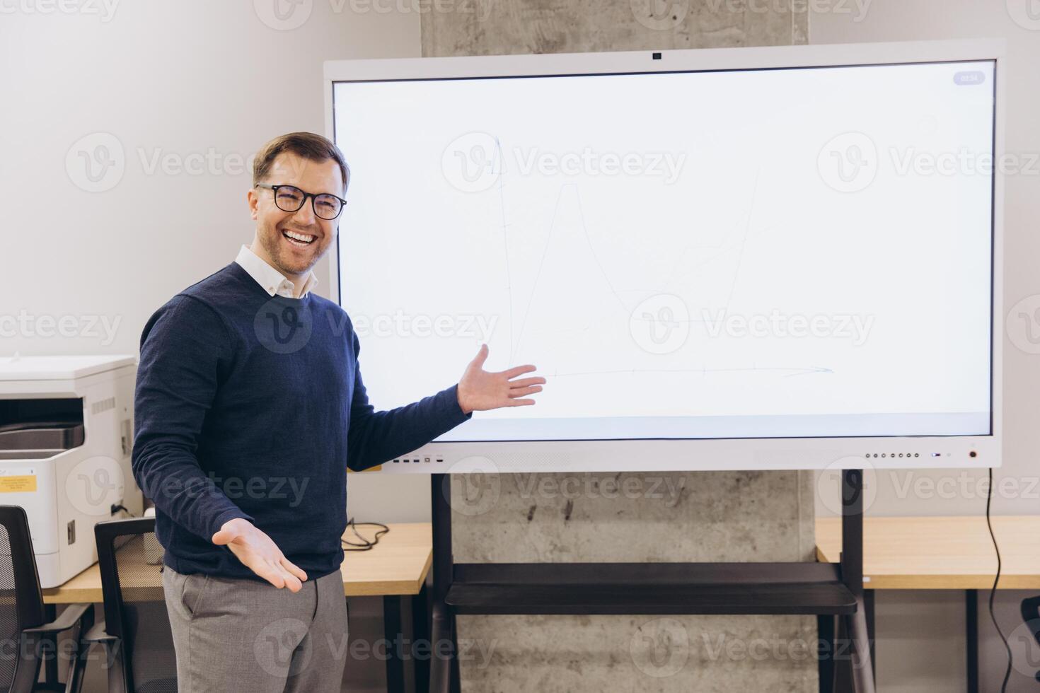Confident businessman enthusiastically presenting data on an interactive whiteboard in a modern office setting, conveying success and innovation photo