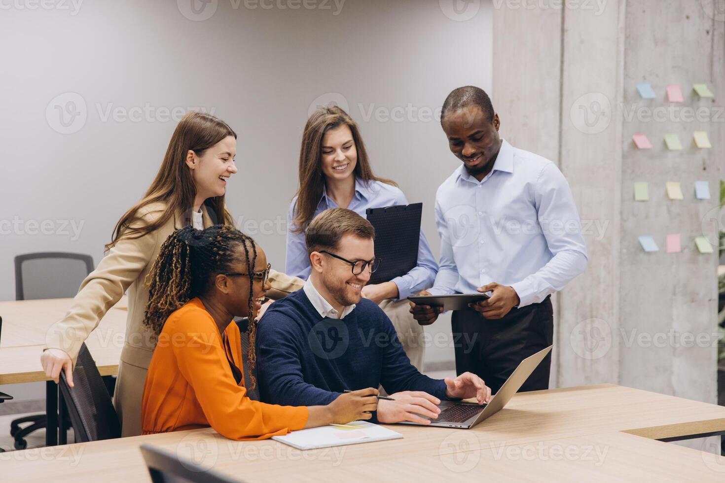 Professionals of different backgrounds working together in a contemporary office, fostering creativity and teamwork with technology and discussion photo