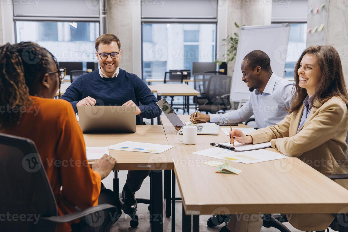 Professional team collaborating during strategic planning session, diverse colleagues brainstorming project details in modern workplace setting photo