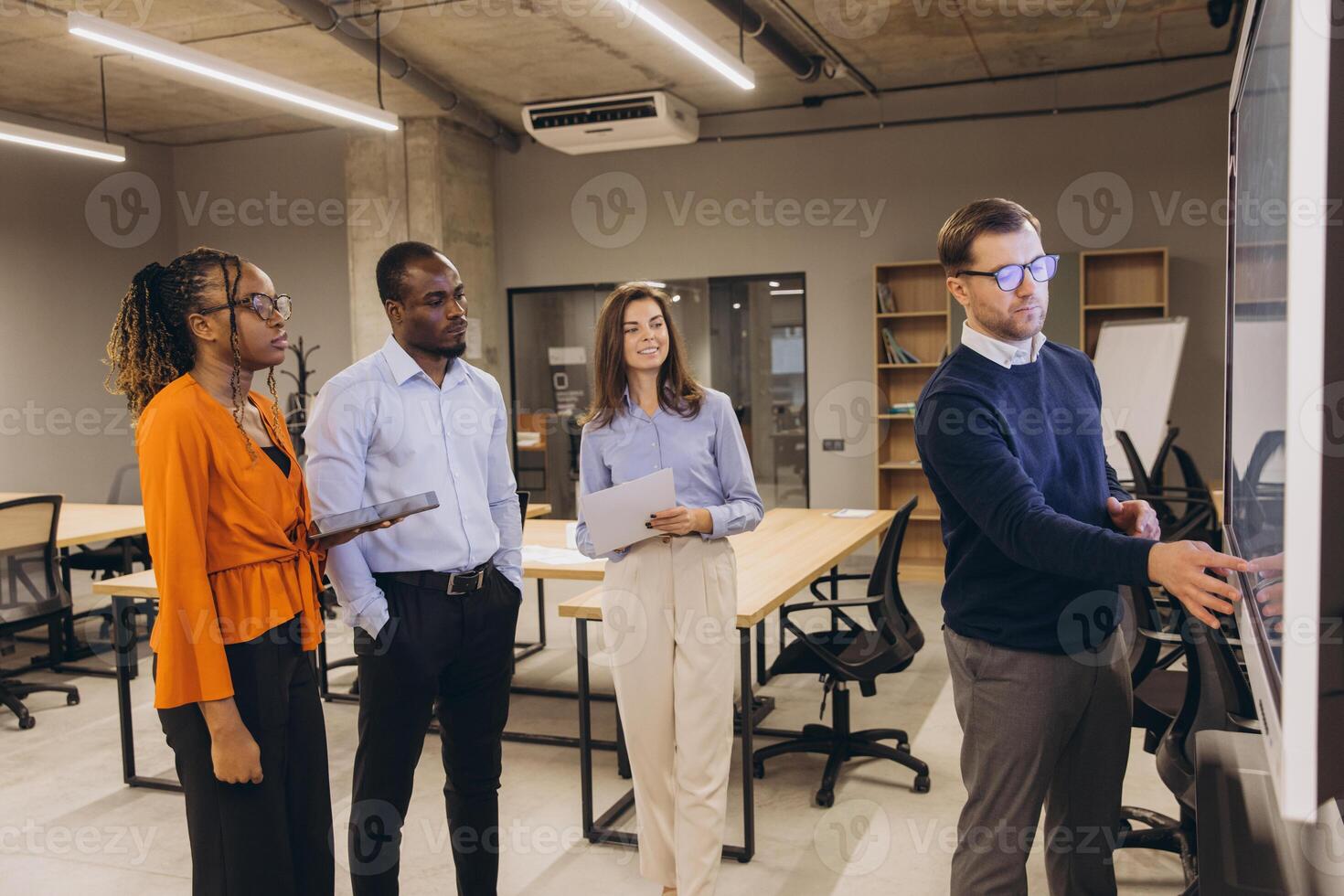 Diverse group of professionals engaged in a collaborative discussion in a modern office environment, highlighting teamwork and innovation photo