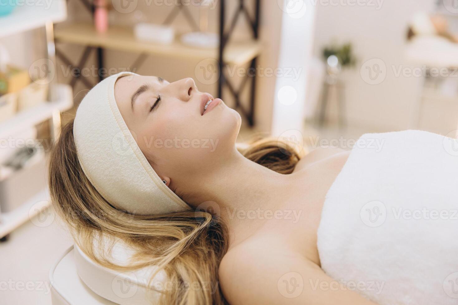 Peaceful woman resting during professional spa massage, experiencing serene wellness moment photo