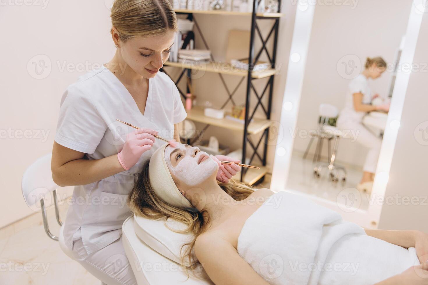 Skilled beautician applying a rejuvenating facial mask to a client in a modern spa setting, promoting relaxation and skincare wellness photo