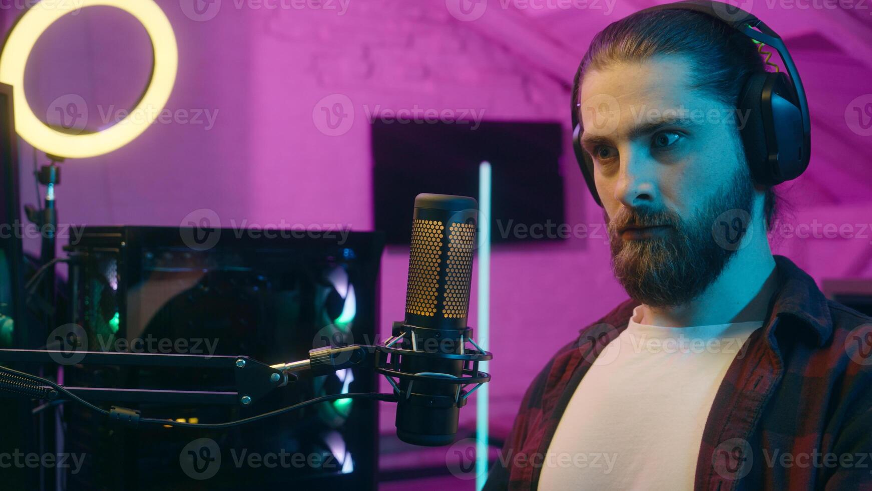 Surprised thoughtful Caucasian streamer addict man guy male influencer thinking pondering at home neon confused gamer stream wonder about game problem puzzled blogger deciding cyber sport gaming blog photo