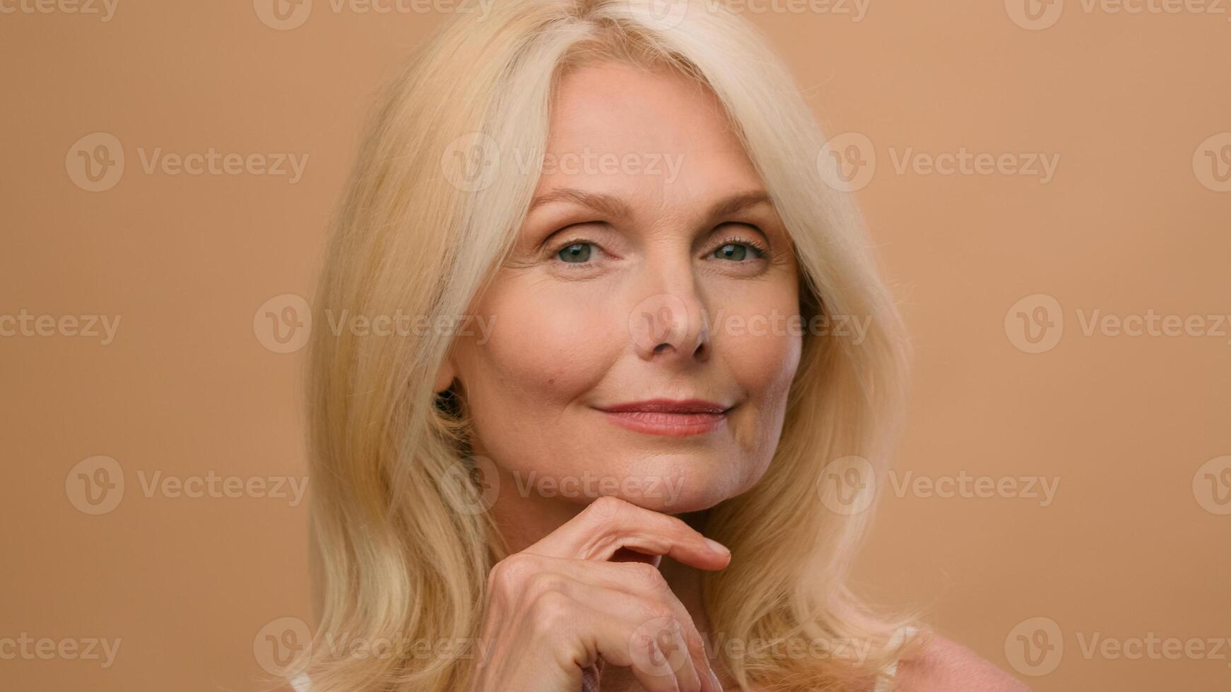 Portrait beautiful old woman perfect face mature Caucasian senior middle age female in beige studio ads of anti-aging lifting skincare hydration plastic surgery anti-wrinkle beauty cosmetics product photo