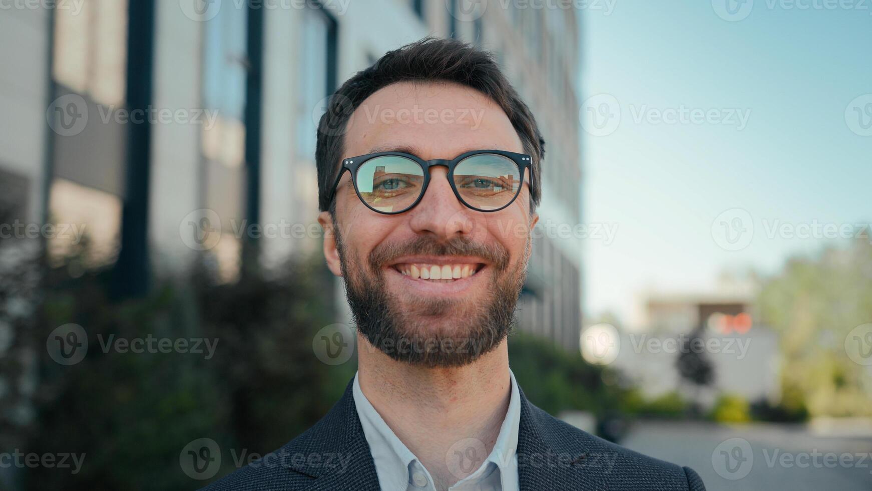 Happy business entrepreneur successful Caucasian businessman near office building outside male portrait smiling guy in spectacles outdoors joyful man CEO leader manager in city cheerful toothy smile photo