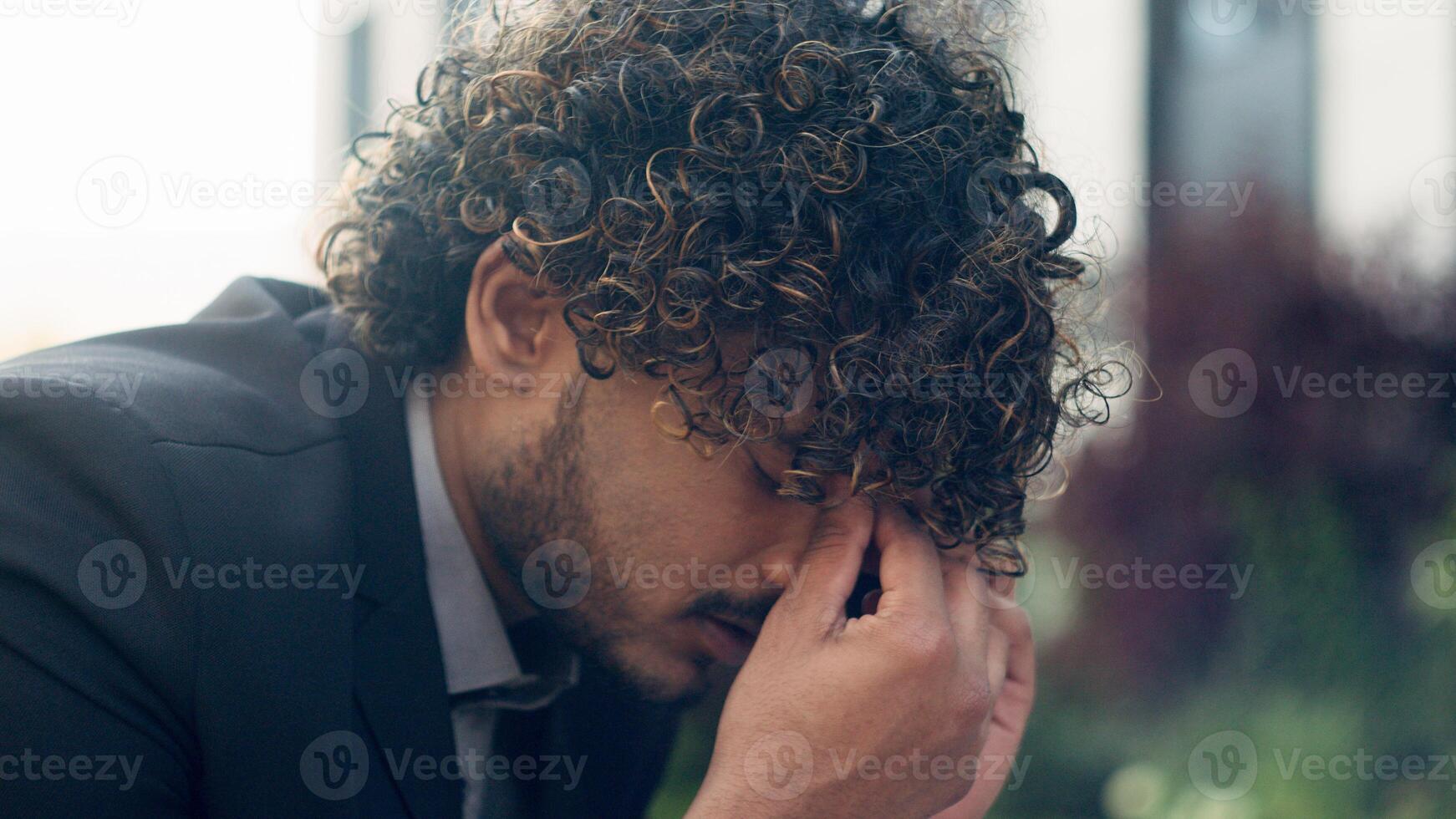 Close up worried Indian businessman stressful Arabian business employer man entrepreneur Hispanic manager talking mobile phone answer call bad news hearing listening problem headache stress in city photo