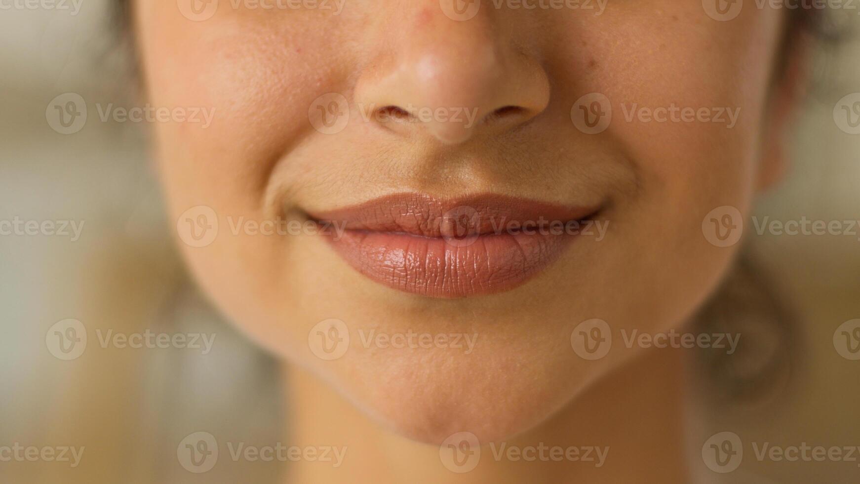 Close up female lips sensual toothy smile white healthy teeth cropped view unrecognizable Indian Arabian woman girl lady female indoors smiling dental oral medicine clinic dentist joyful happy glad photo