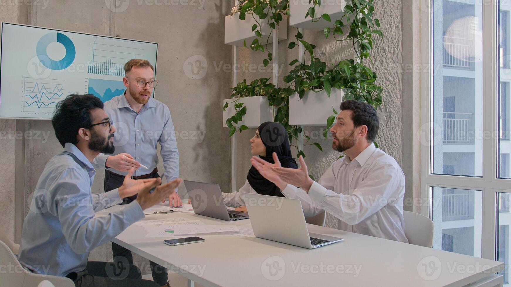 Emotional business team arguing at office discussing financial strategy graphics results diverse multiracial businessmen businesswoman dispute at corporate briefing solve issuess disagreement conflict photo