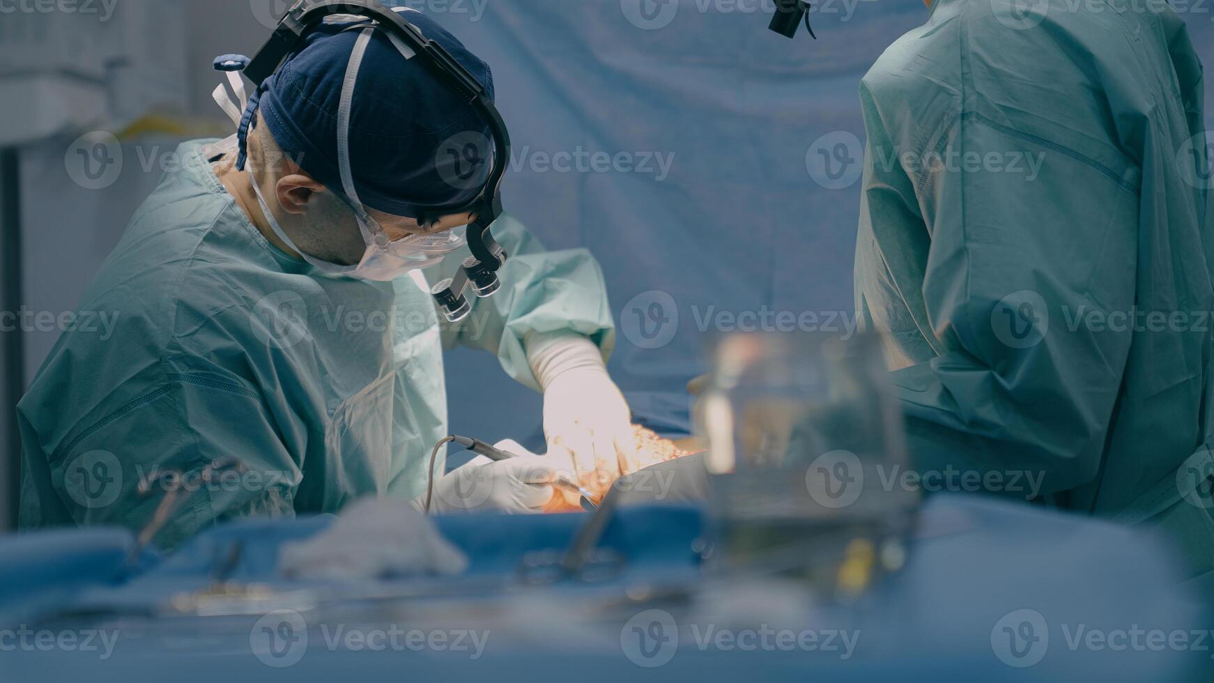 Group of surgeons men doctors physicians in medical masks process surgical operation trauma health treatment medicine aid plastic surgery with scalpel saving life patient in operating clinic hospital photo