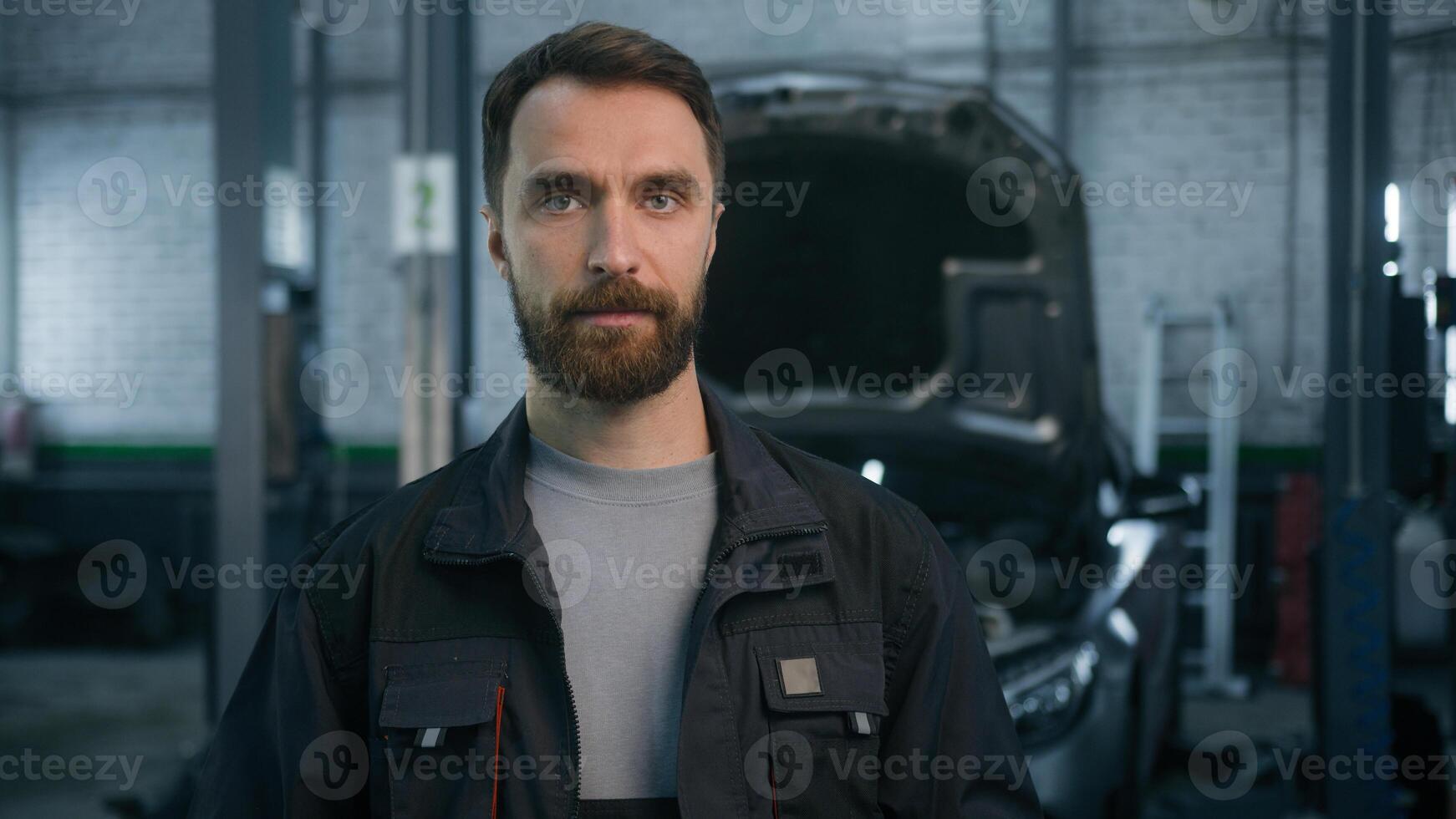 Male portrait Caucasian adult man guy confident serious mechanic engineer repairman industrial worker in uniform technician electrician specialist automobile diagnostics looking at camera car service photo